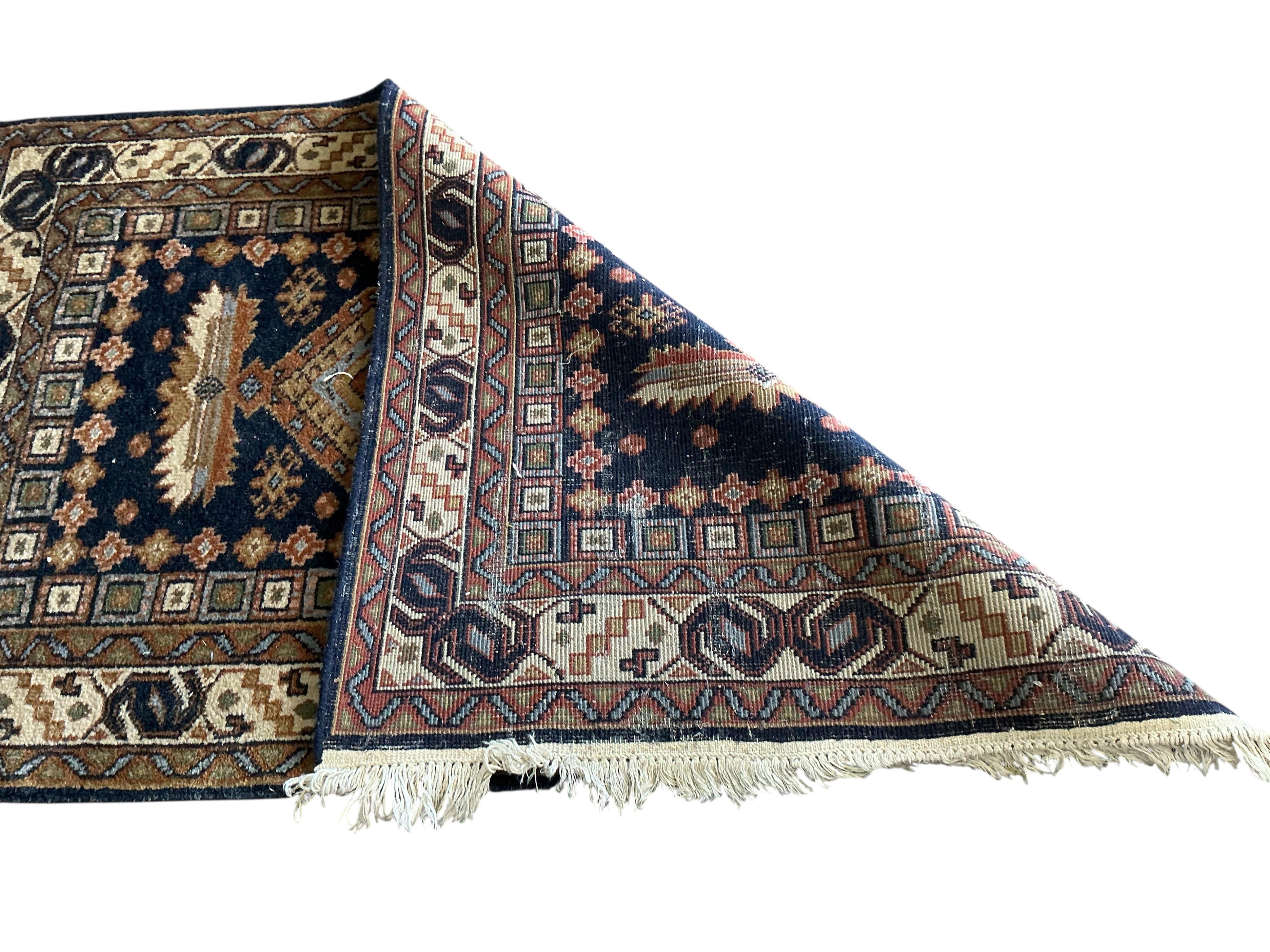 A Bokhara carpet and a smaller Caucasian style rug, larger 290 x 186cm